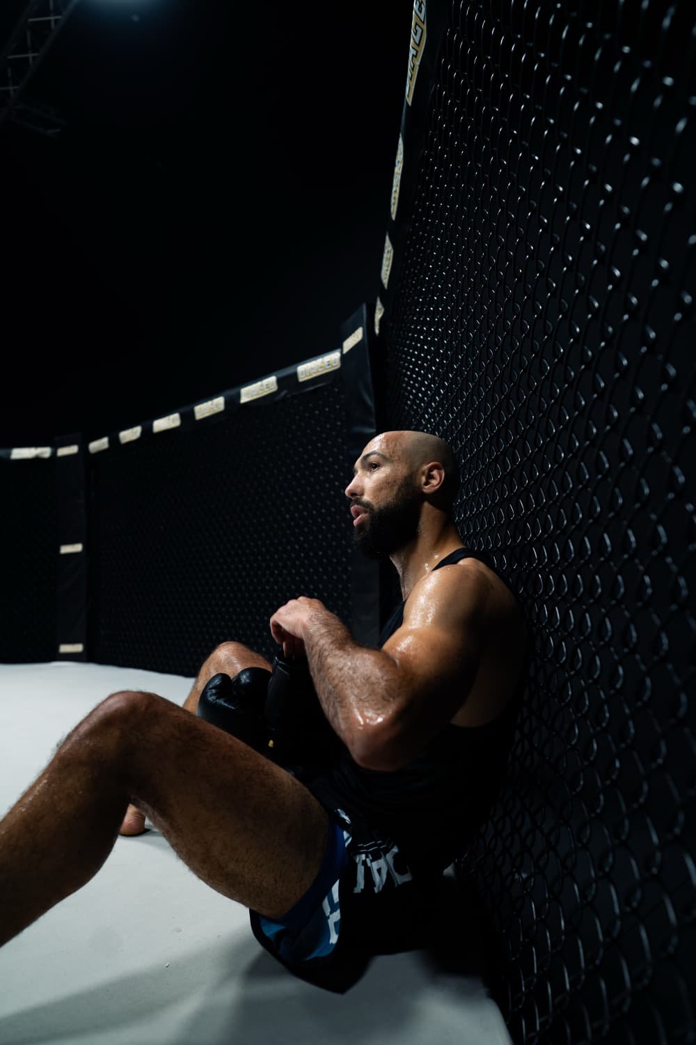 Fighter resting against the cage