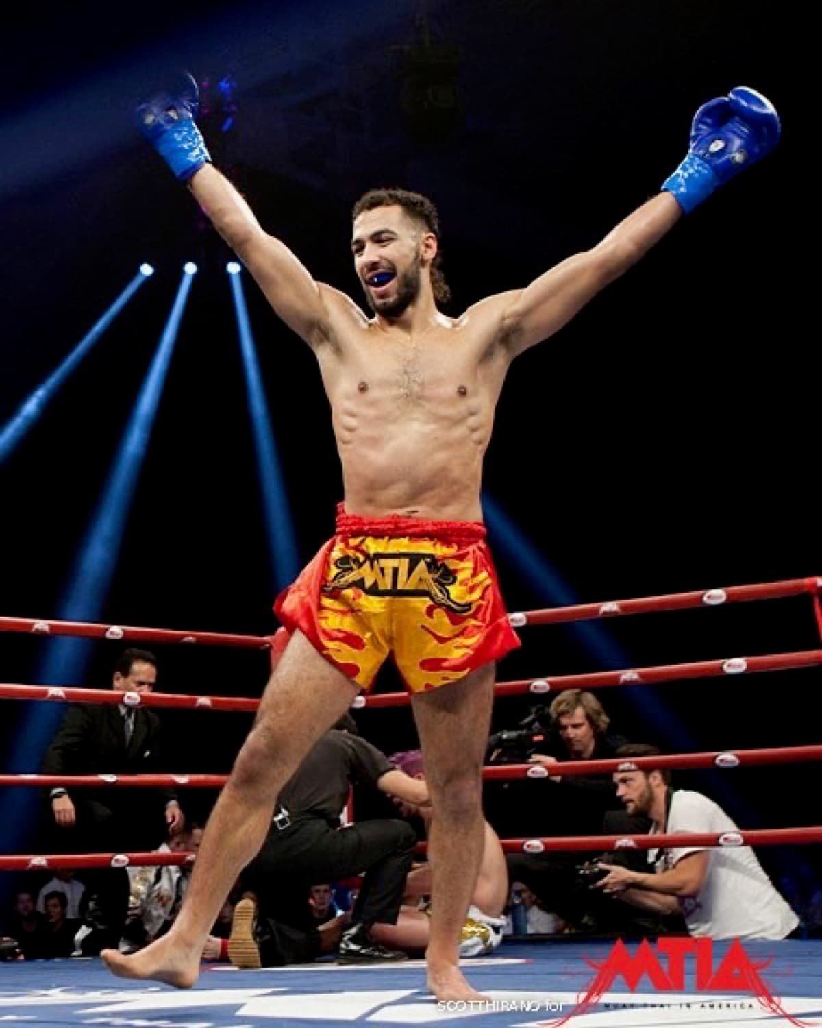 Fighter raising both arms after a win