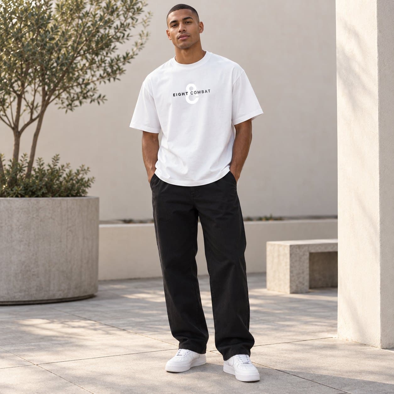 The white tee worn outdoors, front, with black trousers